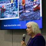 Maradel Krummer Gale speaks during the presentation with a slide show of the adventure on the screen.