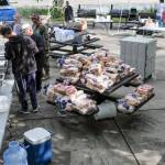 Cooking supplies like piles of buns are piled on top of a table in preparation for the early Juneteenth event in Bremerton.