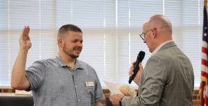 Elisha Meyer/Kitsap News Group
Superintendent Tim Winter, right, leads Andy Brandon in the oath of office at a meeting of the South Kitsap School District school board.