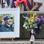 Flowers are set beside a picture of the late Dave Snyder.