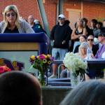 Joanna Pruden offers some opening remarks before a large crowd mourning the loss of Dave Snyder.