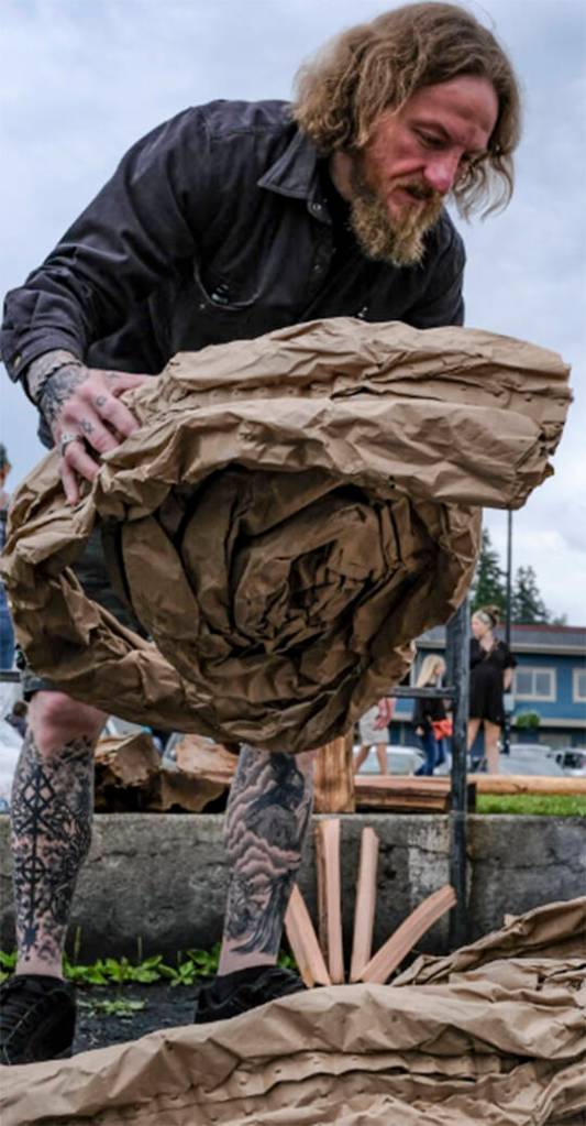 Josh Jarl Washburn helps prepare for the bonfire.