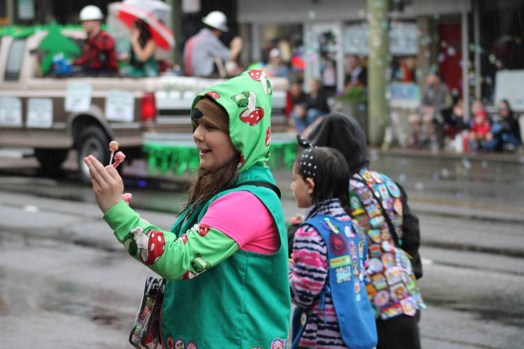 Girl Scouts make their way to the sidewalks to hand out candy.