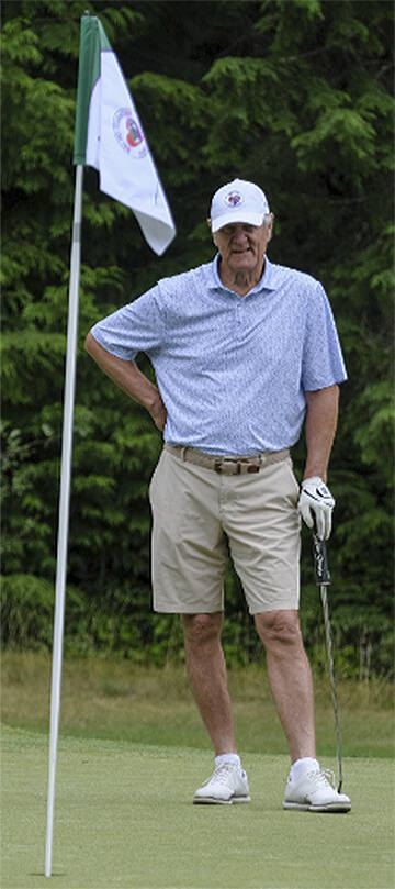 Brian Billick waits for his team members to putt.