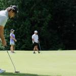Retired Mariners infielder Brett Boone lines up a putt.