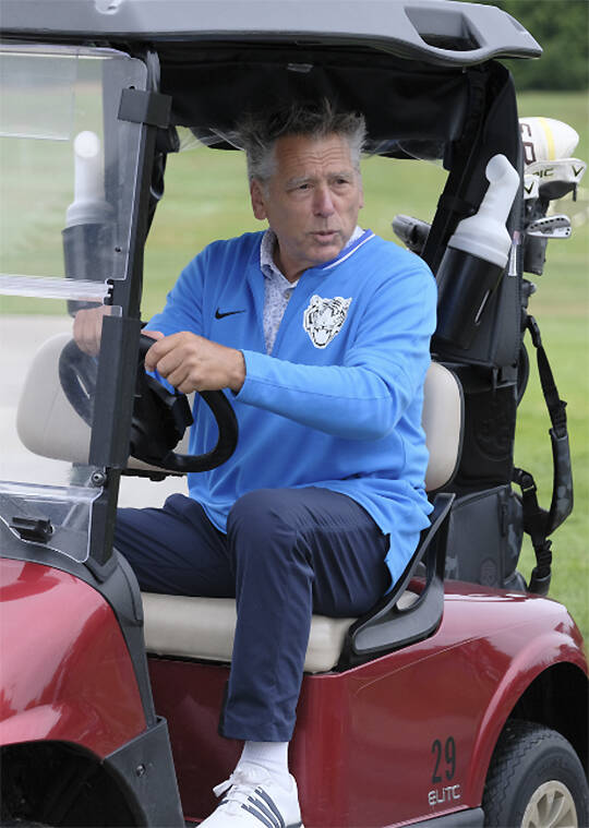 Former Seahawk quarterback Jim Zorn gets behind the wheel of a golf cart.