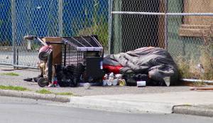 Elisha Meyer/Kitsap News Group
Its unclear whether someone is sleeping inside a sleeping bag amongst a cartload of clutter on the sidewalk of 6th Street in Bremerton.