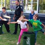 Children tossed Frisbees with officers at National Night Out.