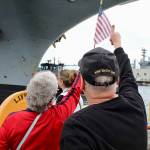 Ann and Scott Case give a thumbs up to their son after spotting him aboard the USS Ronald Reagan.