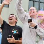 Don, left, and Carley Kunkle jump and wave at the sailor nearest and dearest to them.