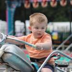 Walker Miller, 2, cruises along on one of the carnival rides