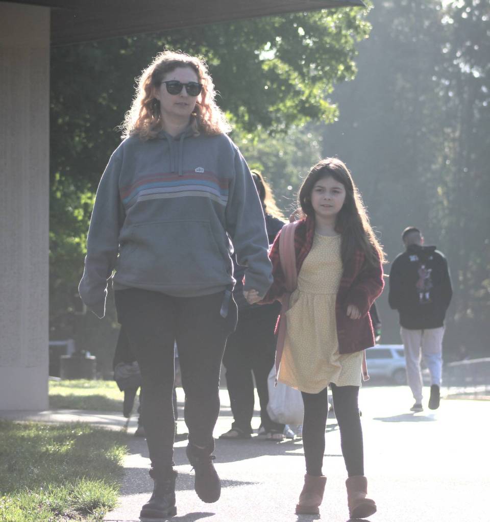 Kirsten Salazar and Sailor walk hand in hand to the front entrance of Sunnyslope Elementary.