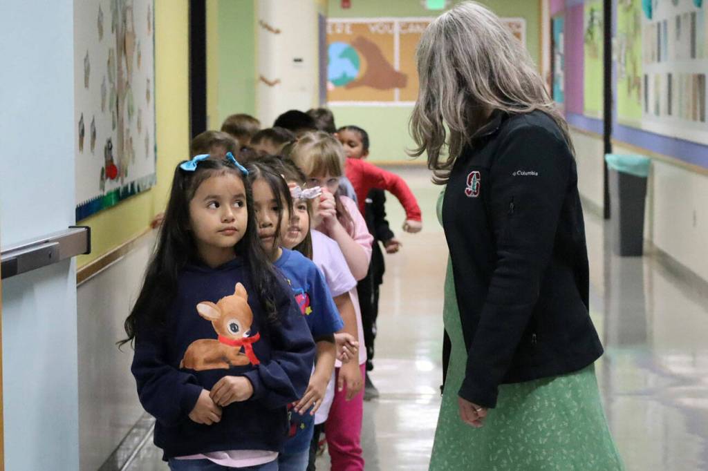 A teacher leads her students to the classroom on the first day of school Aug. 27.
