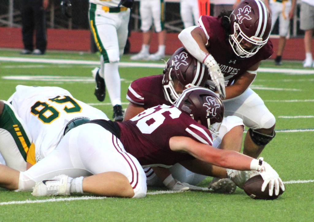 Senior Decan Mulligan-Bowers makes a grab at a Kentridge fumble in the first quarter.