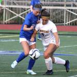 Bainbridge senior Sophia Weindl fights for possession in the first half of a match against Olympic.