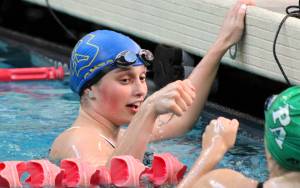 Elisha Meyer/Kitsap News Group
Bremerton swimmer Gabbie Patti offers a fist bump to a Port Angeles swimmer after finishing the 100-yard backstroke.