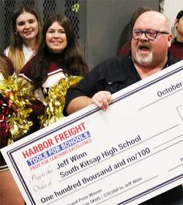 Harbor Freight courtesy photo
South Kitsap High School trades teacher Jeff Winn celebrates receiving a check for $100,000 for himself and his school program Oct. 8.