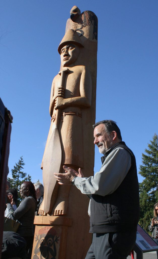Leonard Forsman, chairman of the Suquamish Tribe since 2005, applauds a speech in front of Shweabe.