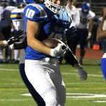 Olympic senior running back Riley McCoy crosses into the end zone for his first of two touchdowns in the game against the Bremerton Knights.
