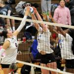 SK sophomore Savannah Browning attempts to tip the ball over the net and past a pair of Curtis blockers.