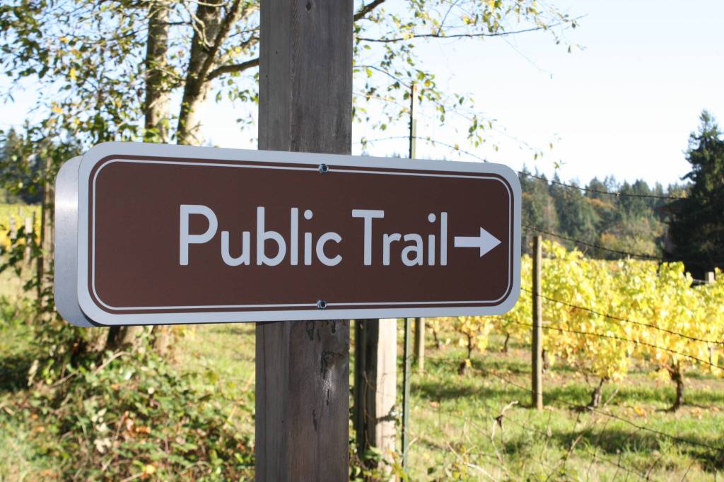 A new public trail sign marks the entrance to the new trail on Day Rd E.