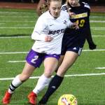 NK senior Ellie Stanford tries to keep possession of the ball against pursuing Spartan freshman Eliza Jurcak.