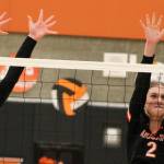 CK sophomore Sydney Lingenbrink, left, and sister Jordan both go up for a block against a Lincoln attacker.