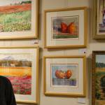 Tyler Shuey/Kitsap News Group photos
Local artist Kim Drew stands next to some of his artwork at the Village Green Community Center in Kingston, which will be on display through Dec. 26.