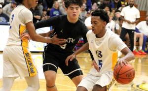 Elisha Meyer/Kitsap News Group
Bremerton sophomore Junior Davis-McWhorter gets inside the arc in a first quarter drive versus the North Kitsap Vikings.
