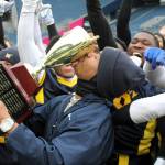 Elisha Meyer/Kitsap News Group photos
Navy coach Jason Henderson from Naval Station Everett certifies his teams 2-0 victory over Army at Lumen Field by planting a kiss of the trophy.
