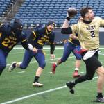 Navys defense tries to pull the flag of Armys scrambling quarterback.