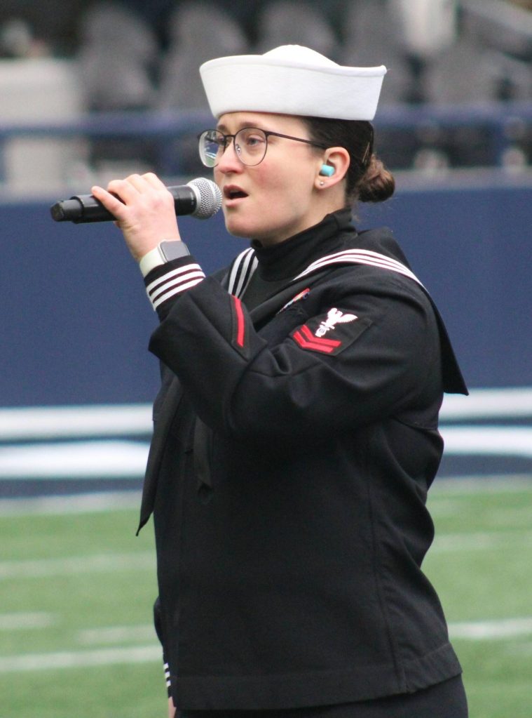 Musician 2nd Class Elizabeth Wetzel sings the National Anthem at Lumen Field prior to the 24th annual Army-Navy flag football game.