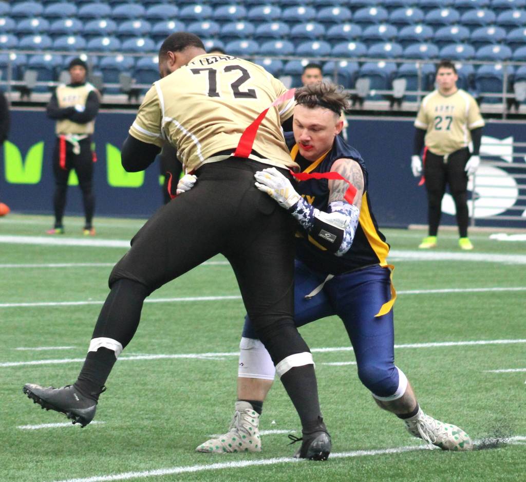 Navy linebacker Gage Pierson, right, wraps up a little too much around an Army receiver, drawing a penalty against Navy.