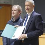 Molly Hetherwick/Kitsap News Group
Tyler Shuey of the Review, left, accepts a proclamation from BI Mayor Joe Deets declaring Dec. 10 Bainbridge Island Review Day in honor of the newspapers 100th anniversary.