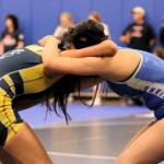 Olympics Natanee Stone, right, locks with a wrestling opponent on the mat.