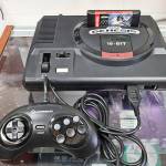A Sega Genesis console with a controller and game.