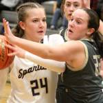 Luke Caputo/Kitsap News Group photos
Bella Ramirez of Bainbridge holds the ball as Teegan DeVries of North Kitsap plays tight defense in a 33-20 Spartan win in the semifinals of the District 3 2A girls basketball tournament Feb. 20 at Foss High School.