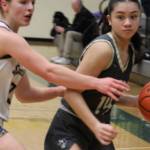 Abby Marrero of NK looks to make a play with Sierra Berry of Bainbridge guarding her in a 33-20 loss to the Spartans Feb. 20 at Foss High School.