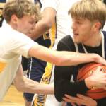 Bremerton Knight Dallin Anderson wrestles for the ball with Bainbridge Spartan Charlie Hill.