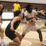 Luke Caputo/Kitsap News Group photos
Enoch Taylor of Bremerton avoids incoming Lakewood defenders in a 62-44 Knight win in the first round of the 2A state boys basketball tournament at the University of Puget Sound in Tacoma March 1.