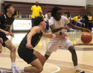 Luke Caputo/Kitsap News Group photos
Enoch Taylor of Bremerton avoids incoming Lakewood defenders in a 62-44 Knight win in the first round of the 2A state boys basketball tournament at the University of Puget Sound in Tacoma March 1.