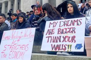 Mary Feusner courtesy photo
Protesters held up signs in support of Latino culture and immigrants to the United States March 10 in Olympia.