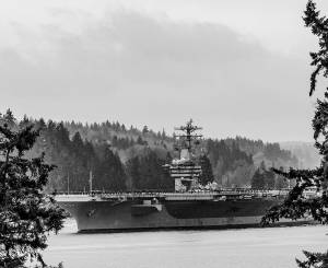 Patrick Coonan courtesy photo
The aircraft carrier USS Nimitz goes through Rich Passage on an early foggy morning March 21 after leaving Bremerton with its sailors on its deck on its way to retirement in Norfolk, VA.
