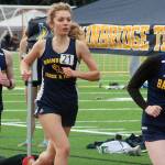 Bainbridge track athletes Mairin OBrien (front), Nova Sheppard, and Michael Sanders compete in a meet against North Kitsap March 24 at Bainbridge High School.