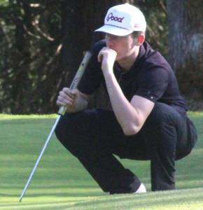 Luke Caputo/Kitsap News Group photos
Spartan Samuel Hodus evaluates a put in a 155-237 Spartan win over the Kingston Buccaneers April 3 at White Horse Golf Club.
