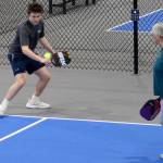 A player hits a backhand during a friendly match.
