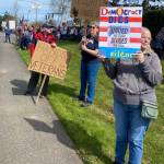 Community members displayed signs in opposition to the Trump administration.