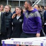 North Kitsap track and field coach Ryan Ferenci walks in a ceremonial first lap in honor of former Vikings track coach Dave Snyder who died last year.