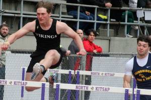 Luke Caputo/Kitsap News Group photos
Viking Theo Sterns, left, competes in a hurdling event with a Bainbridge runner on his heels April 19 at the Lil Norway Invitational track meet at North Kitsap High School.