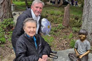 Poulsbo Parks and Recreation courtesy photos
99-year-old Ardis Morrow, front, and artist Jeff Oens stand next to the statue of Eli Creekmore at Rotary Morrow Community Park in Poulsbo April 19.